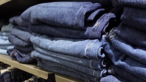 stacked blue jeans on shelves