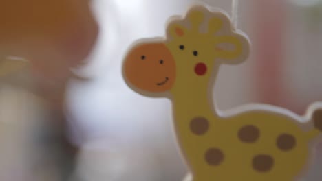 close-up of a colorful giraffe toy with a soft focus background, warm indoor lighting