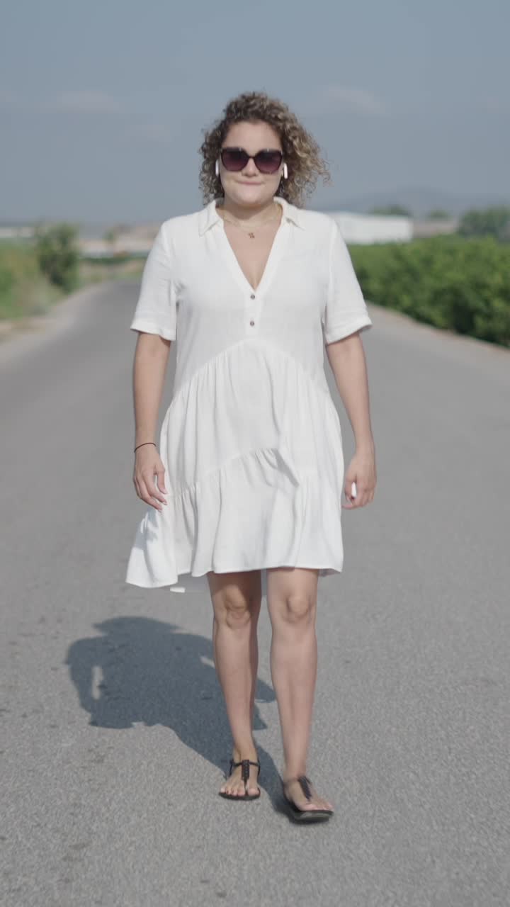 Woman in White Dress Walking on Rural Road