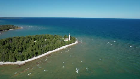 drone aerial shot flying in towards the old baileys harbor bird cage lighthouse