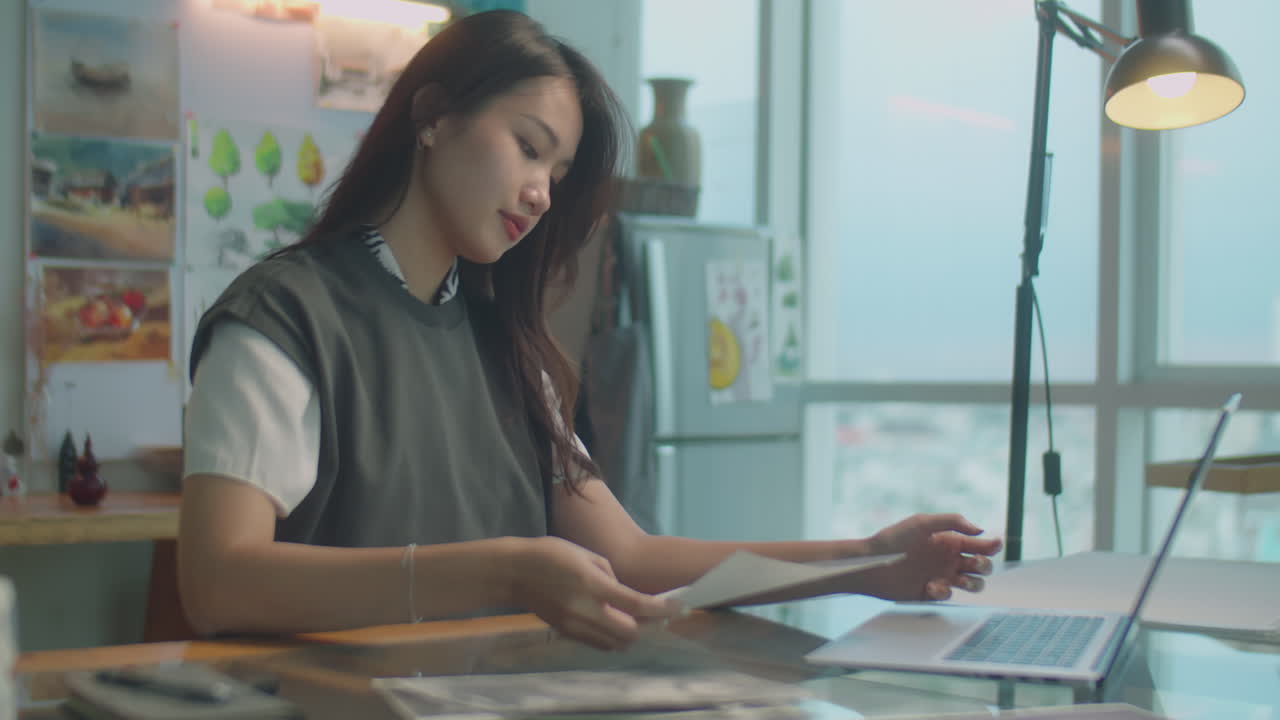 Asian Woman Working on Laptop in Art Studio