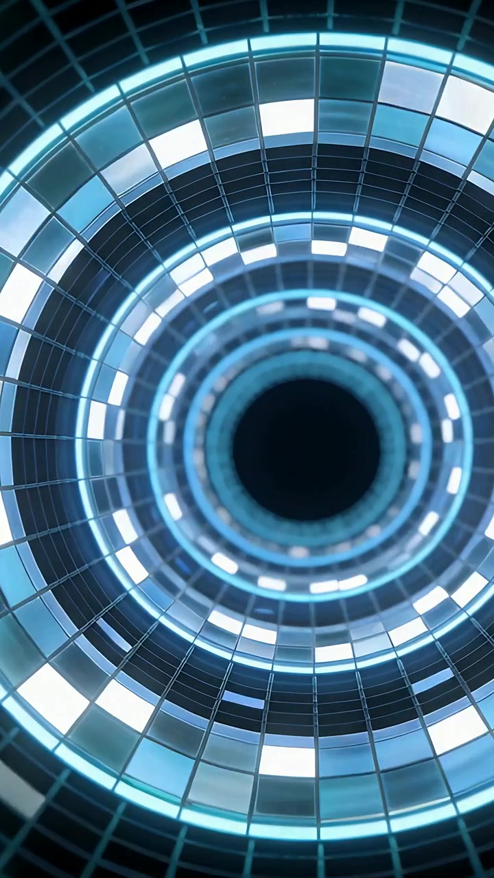 Video verticale: Anelli concentrici illuminati che ruotano all'interno di un tubo piastrellato, inviando dati verso il vuoto.