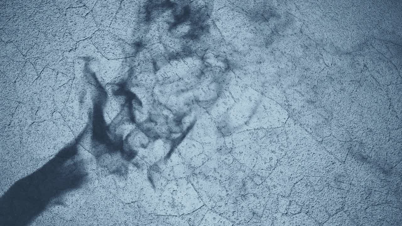 Shadow of a Hand Against Textured blue Background