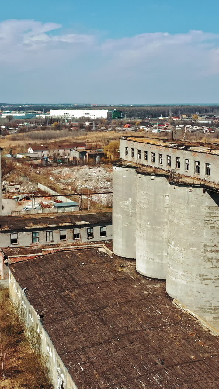 Flight over the destroyed factory. Old industrial building for demolition. Aerial view Vertical video