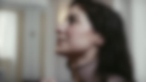 blurred close up shot of woman praying in front of an altar with folded hands in a catholic church