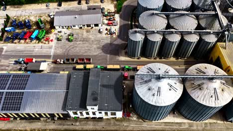 aerial view of an industrial complex with silos and solar panels