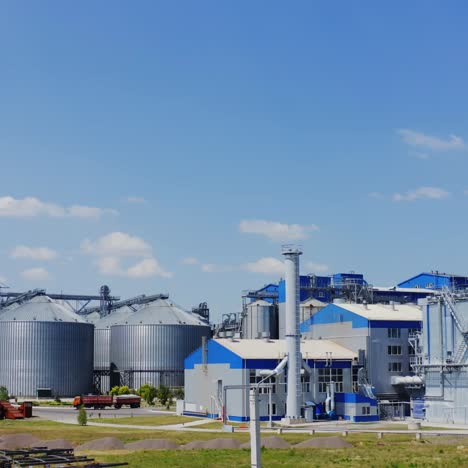 exterior of modern plant. large metal containers for grain storage on the industrial territory. steel elevators for storing harvest.