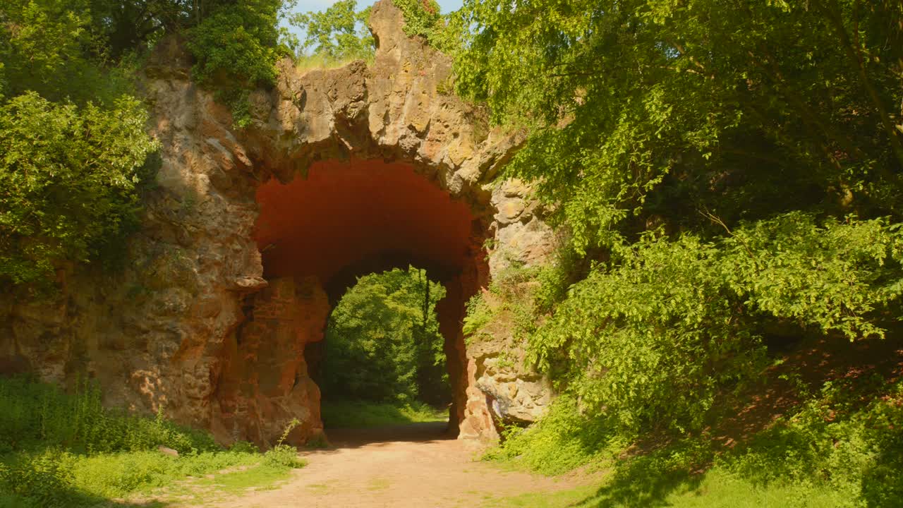 Famous Rock Bridge With Green Foliage At Bois de la Cambre Park In Brussels, Belgium