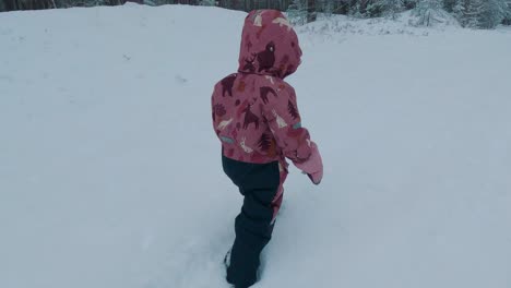 child exploring deep snow