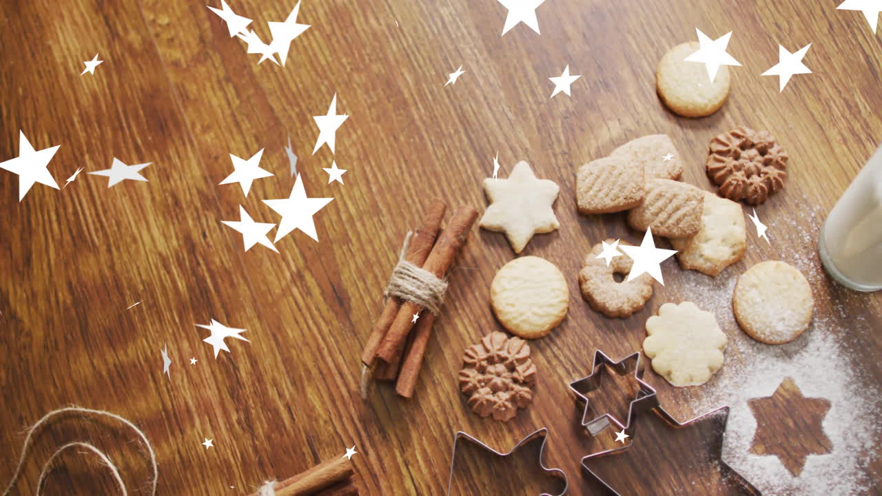 animación de estrellas cayendo sobre las galletas de navidad en la mesa