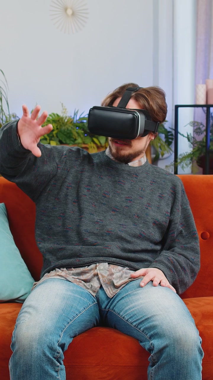 Bearded man use virtual reality futuristic technology headset play simulation 3d video game at home