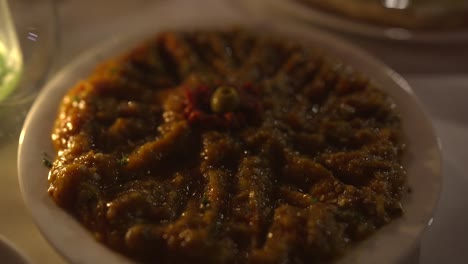 moroccan appetizer eggplant roasted pepper dish by candle light