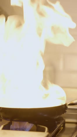 flambé cooking technique in a professional kitchen
