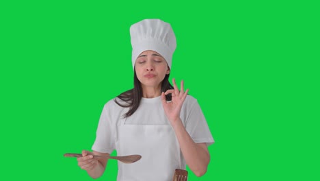 Happy-Indian-professional-chef-tasting-her-food-Green-screen