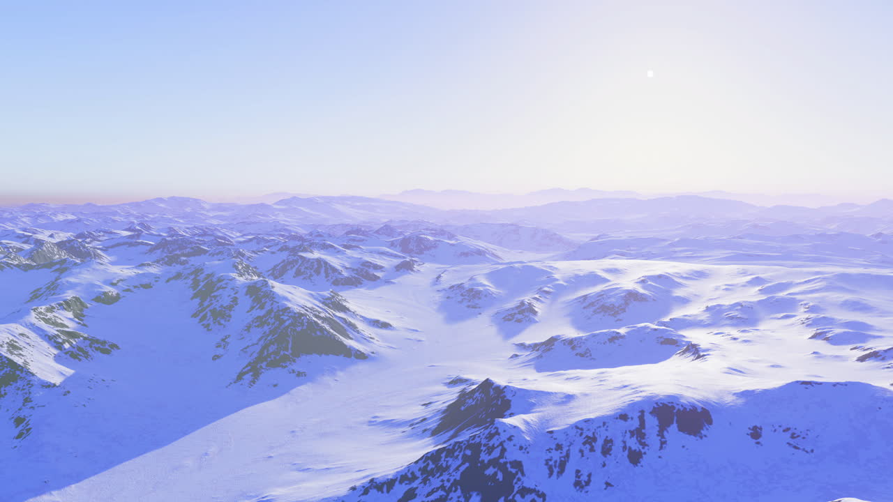 Snow covered mountains under a bright sky at dawn in winter season