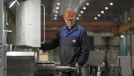 factory worker inspecting machinery