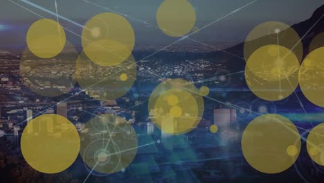 Animation-of-network-of-connections-and-yellow-dots-over-cityscape