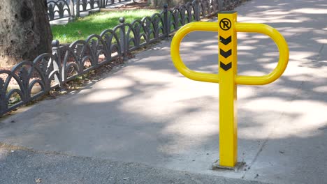 yellow parking post on a city street