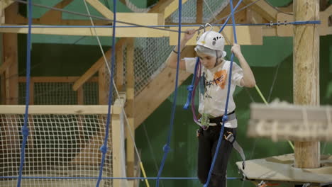 child on an indoor ropes course adventure