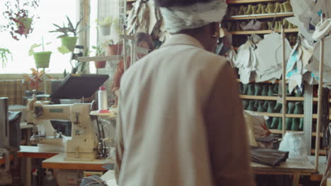 african american woman working in shoemaking workshop