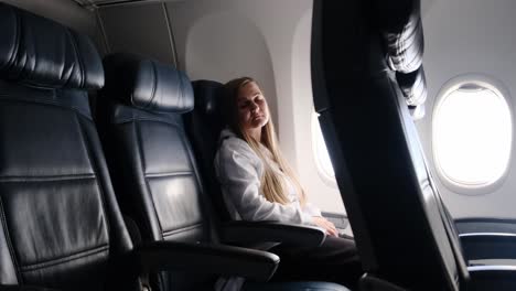 a calm traveler sleeps peacefully by the window in a spacious airplane during a relaxing flight in the usa, capturing a quiet and restful travel moment