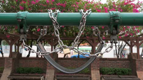 a locked swing play is seen at a closed public playground to the covid-19 coronavirus outbreak and restrictions in hong kong