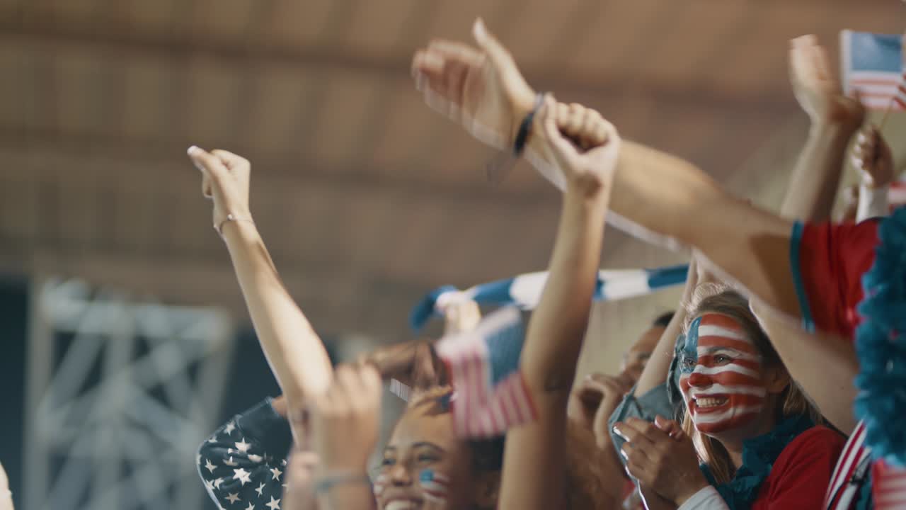 Group of USA supporters applauding in stadium
