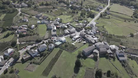 aerial footage of village with green fields and trees, abeleda, spain