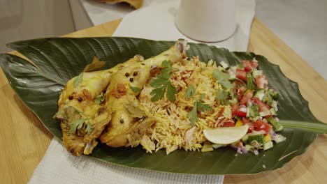 view of biriyani chicken rice on a palm tree leave