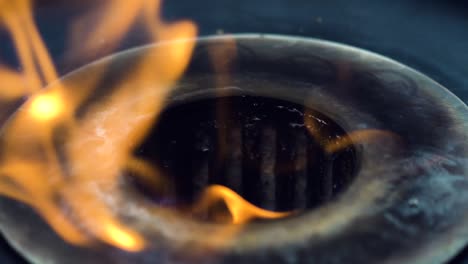 flames coming out from an industrial gas stove in a restaurant, close up 4k