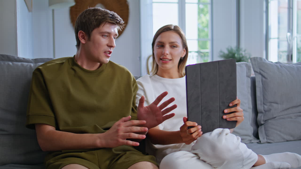 Boyfriend girlfriend video calling sitting apartment couch together closeup