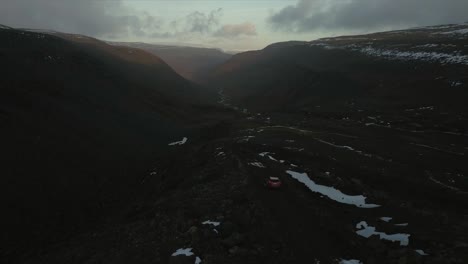 Car-driving-through-snowy-hills