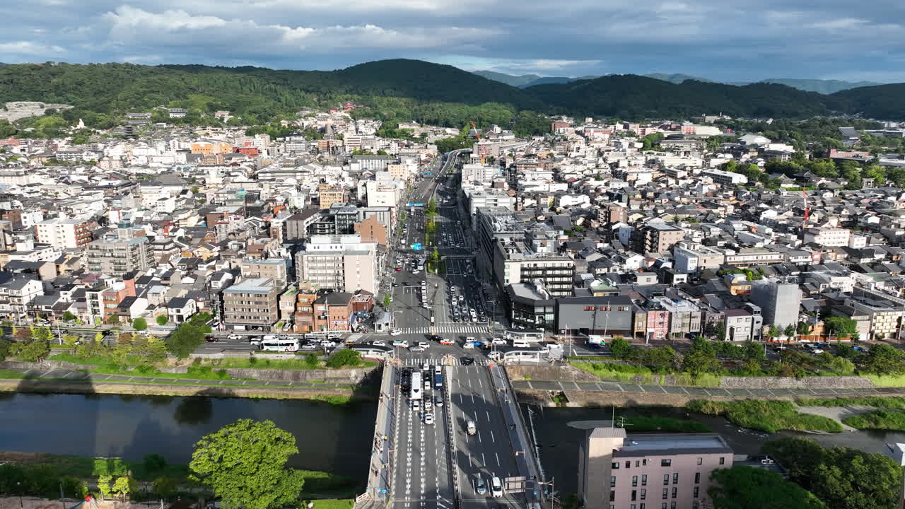 Kyoto City Buildings, Traffic, Street, Shijo Bridge Over Kamo River In Japan. - aerial shot