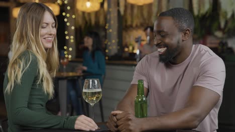 Tracking-Shot-of-Man-and-Woman-On-a-Date-In-a-Bar