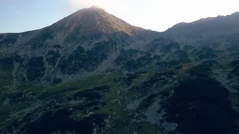 Wide-aerial-drone-slowly-climbing-up-through-a-mountain-range