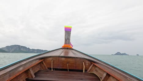 boat travels through ocean towards distant islands