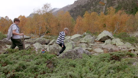 family hiking in autumn mountains