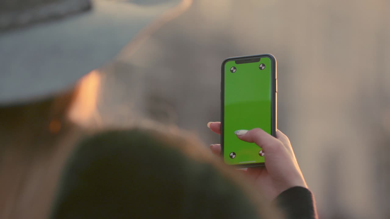 Young woman fingers typing on her smartphone