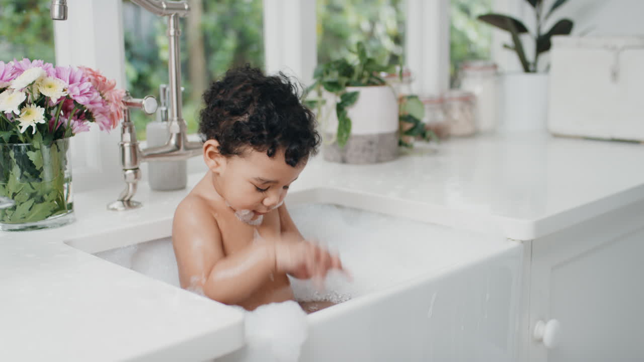 happy baby bathing funny toddler taking bath in kitchen sink having fun with soap bubbles 4k