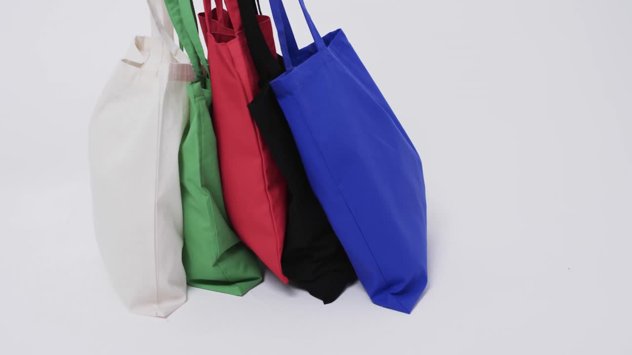vídeo de bolsas de lienzo multicolores con espacio de copia sobre fondo blanco