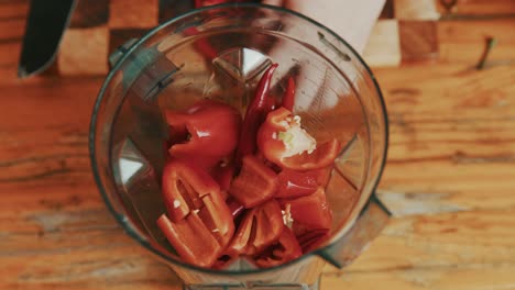 Adding-bell-peppers-with-red-chilli-in-a-grinder-for-sauce