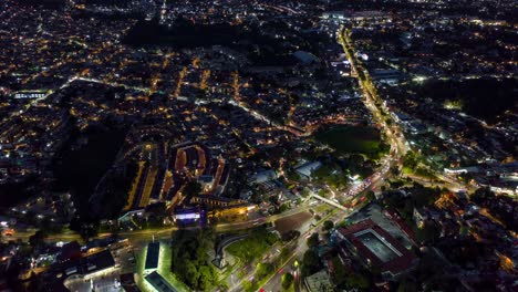 aerial hyperlapse flying over mexico city viaduct traffic as night falls