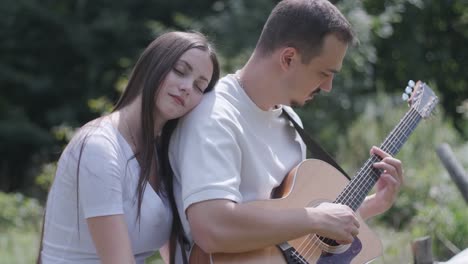 Couple playing guitar together