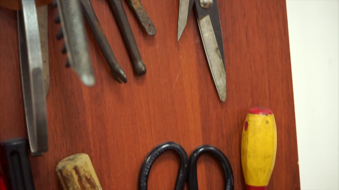 Various Tools on a Wooden Panel