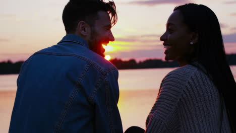 couple enjoying a romantic sunset by the lake