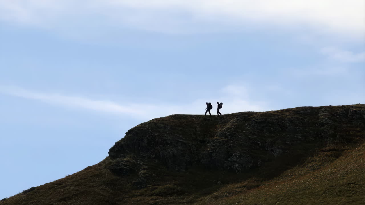 Hikers Silhouetted on a Mountain Ridge