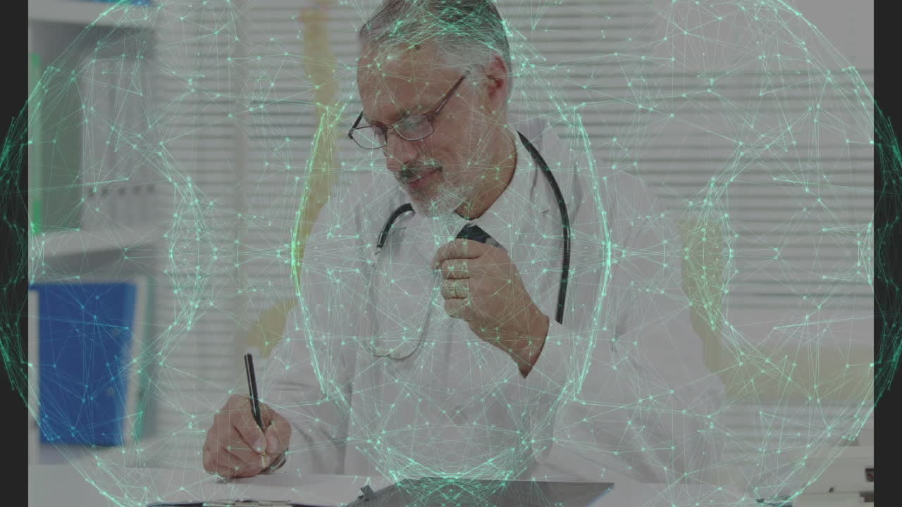 Senior male doctor writing notes on clipboard in medical office, showing animated health icons