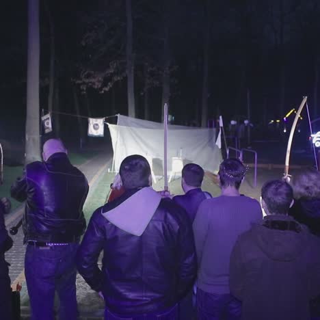 people aims a bow at a target