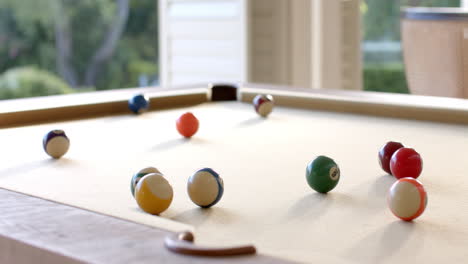 billiard balls scattering across small table