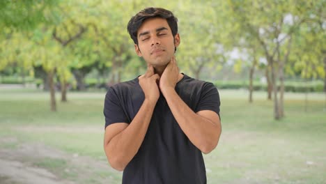 Indian-boy-doing-neck-exercise-in-park